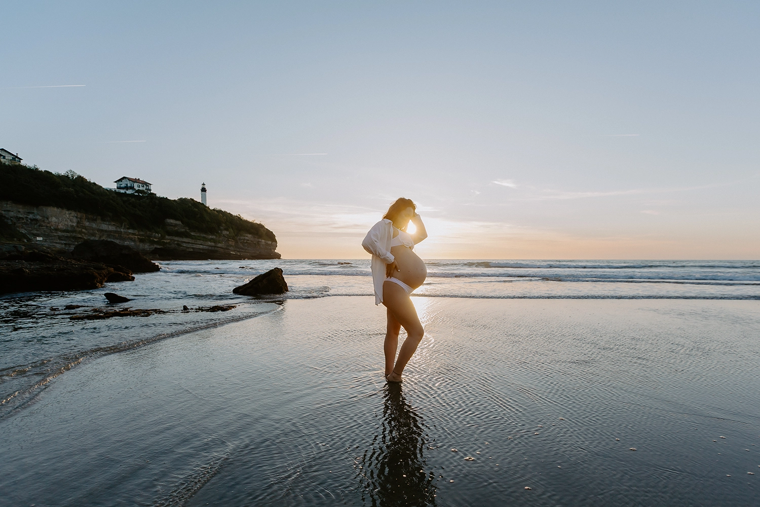 Future maman pendant une séance photo grossesse sur la plage d'Anglet